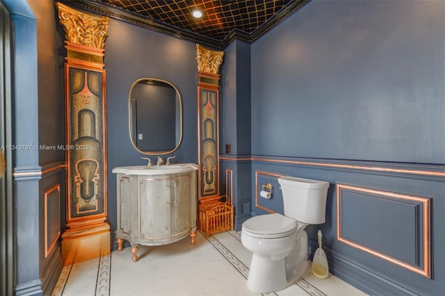 bathroom with crown molding, toilet, tile floors, and vanity