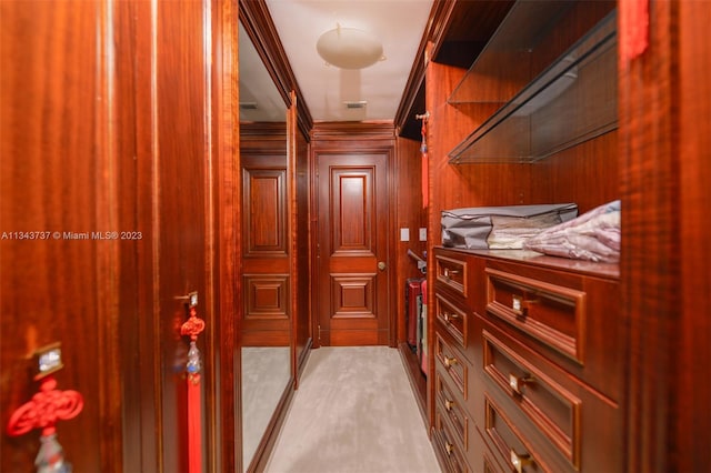 walk in closet featuring light colored carpet