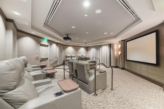 carpeted home theater with a raised ceiling