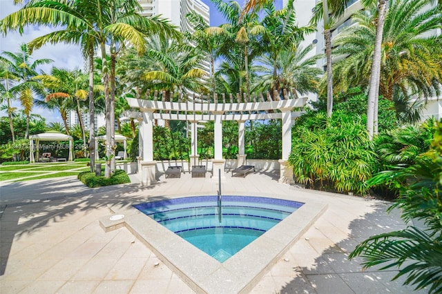 view of swimming pool featuring a patio, a pergola, a gazebo, and an in ground hot tub