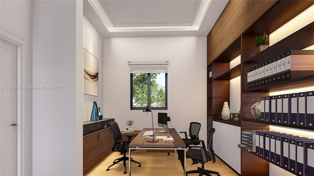 home office featuring a raised ceiling, ornamental molding, and light wood-type flooring