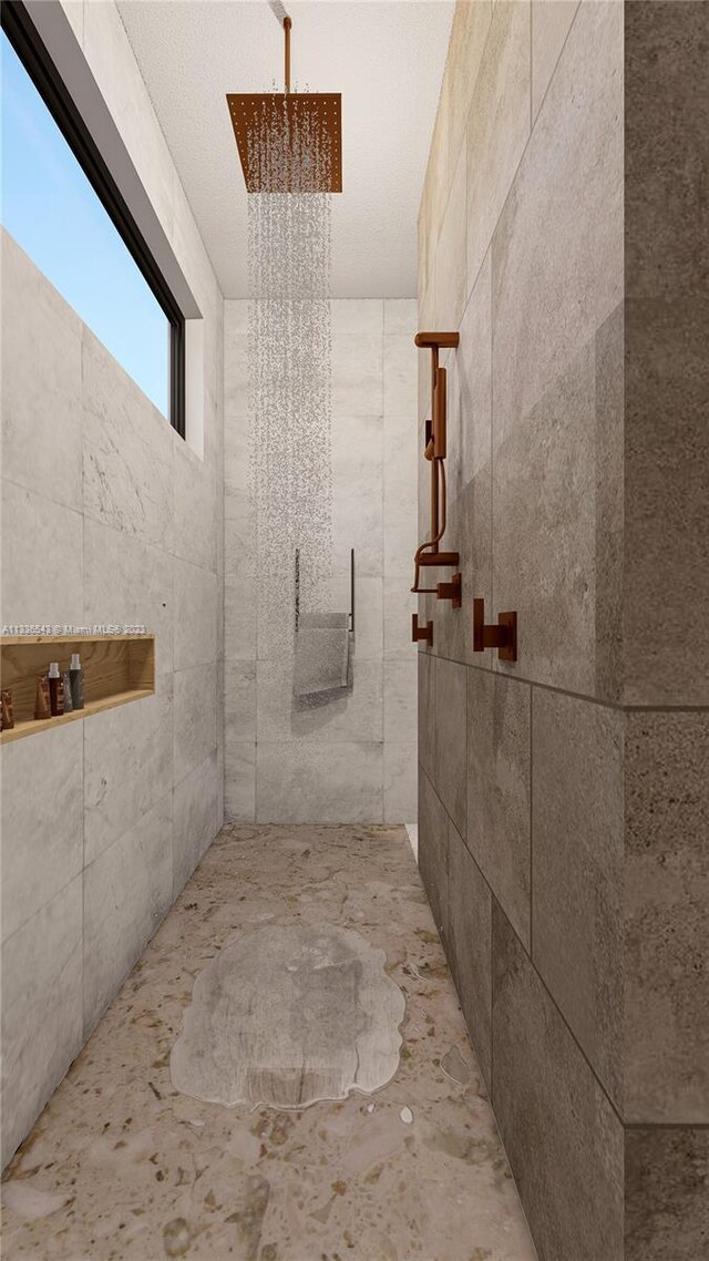 bathroom with tiled shower