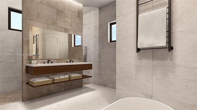 bathroom featuring sink and tile walls