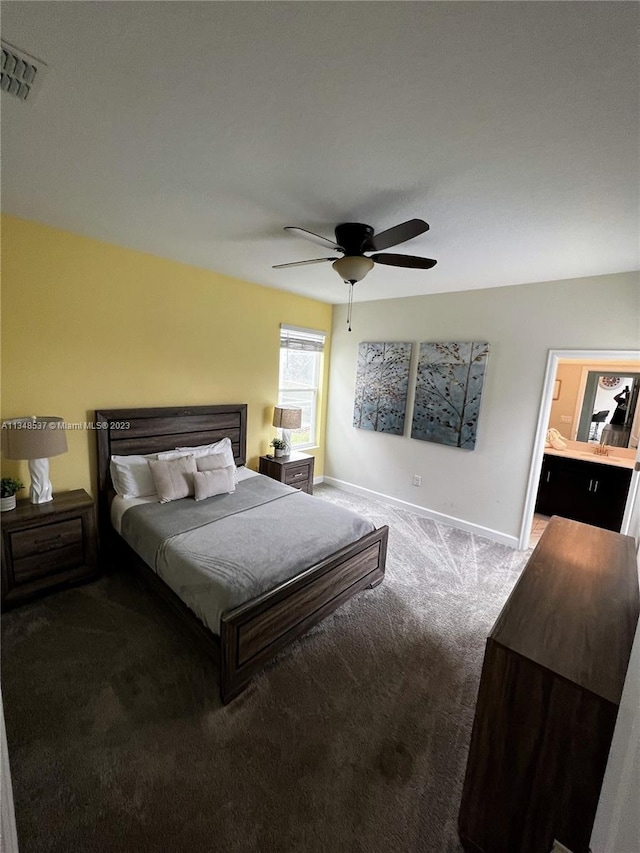 carpeted bedroom featuring connected bathroom and ceiling fan