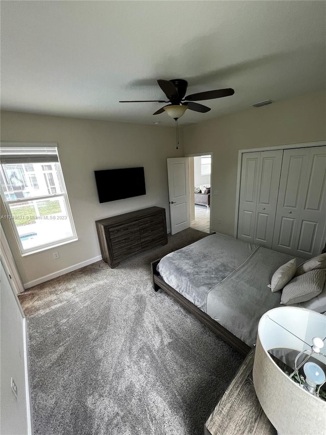 carpeted bedroom featuring a closet and ceiling fan