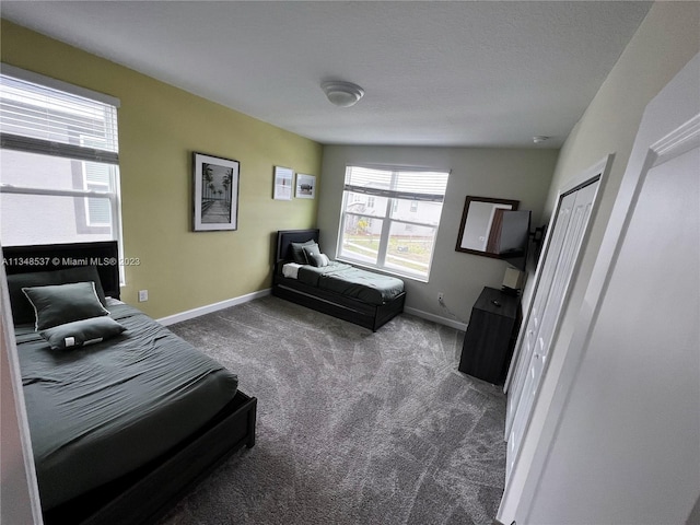 carpeted bedroom with a closet and a textured ceiling