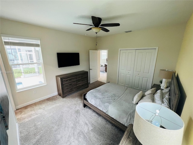 bedroom with a closet, carpet floors, and ceiling fan