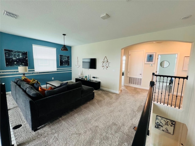 living room featuring carpet and a textured ceiling