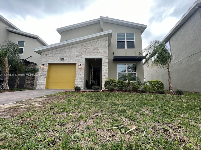 view of front of property with a front lawn and a garage