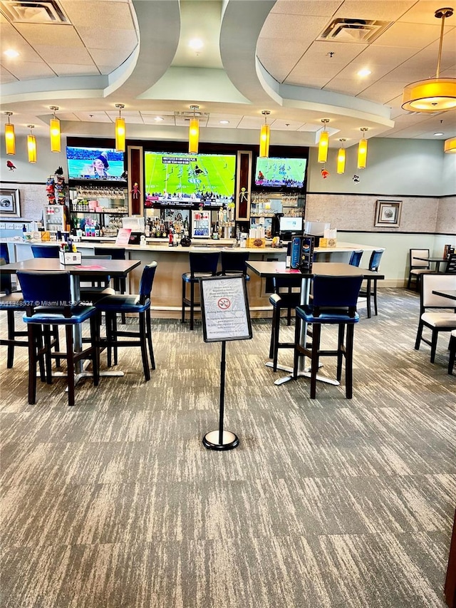 carpeted dining area featuring a tray ceiling