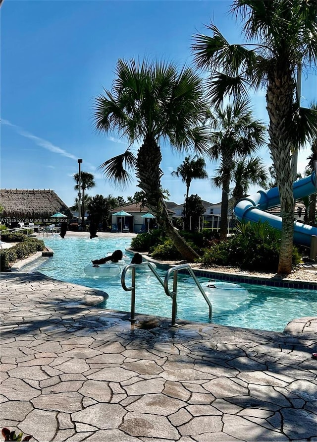 view of swimming pool with a water slide