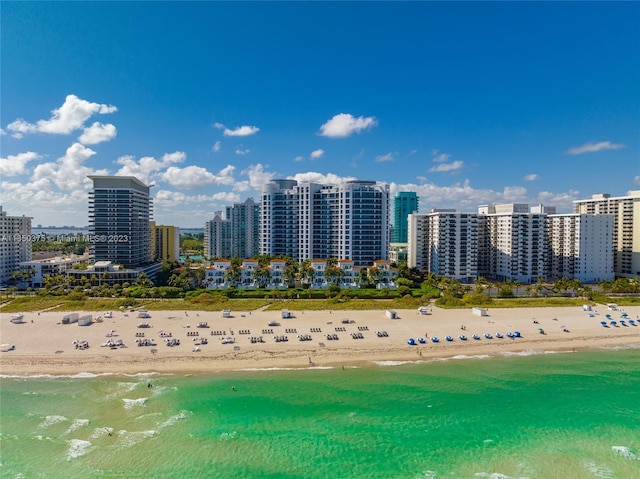 birds eye view of property with a water view and a view of the beach