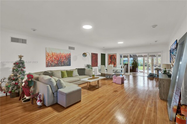 living room featuring french doors and light wood-type flooring