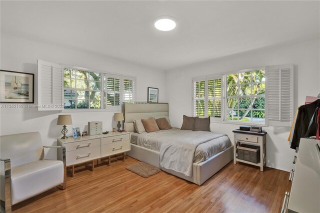 bedroom with hardwood / wood-style flooring