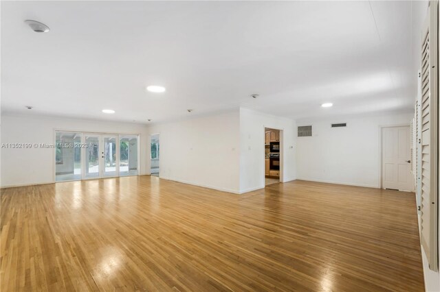 spare room featuring wood-type flooring