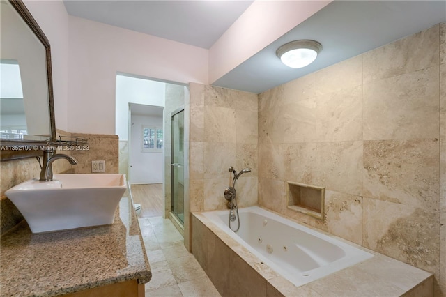 bathroom featuring vanity, plus walk in shower, tile floors, and tile walls