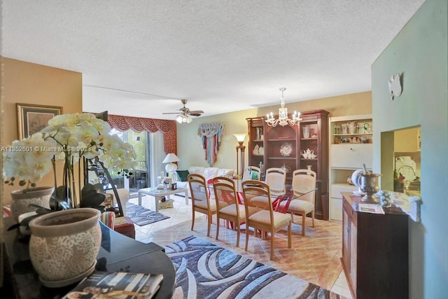 tiled living room featuring a textured ceiling and ceiling fan with notable chandelier