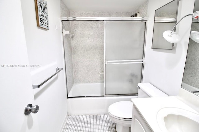 full bathroom featuring enclosed tub / shower combo, toilet, tile flooring, and vanity