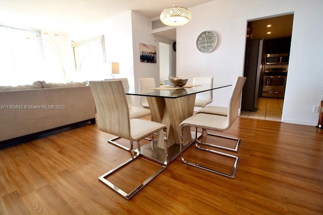 dining room with light wood-type flooring