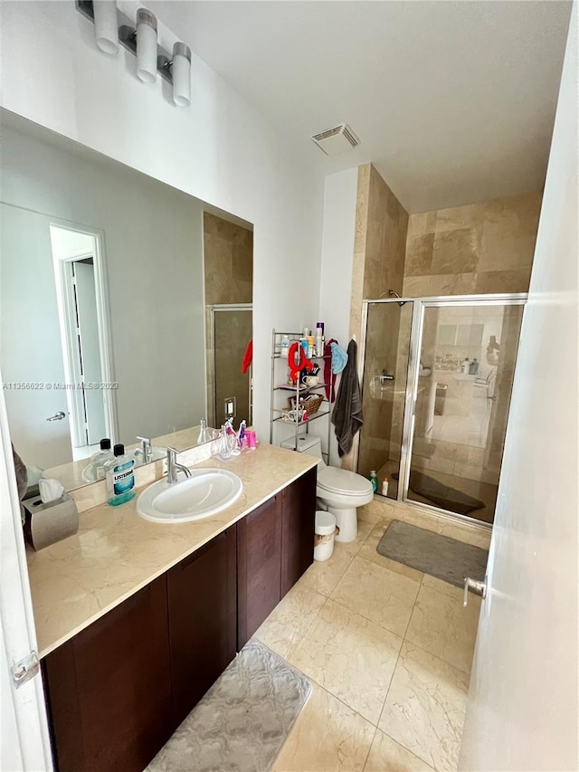 bathroom with an enclosed shower, toilet, vanity, and tile flooring