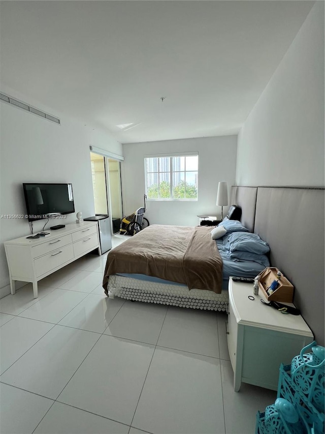 bedroom with light tile flooring