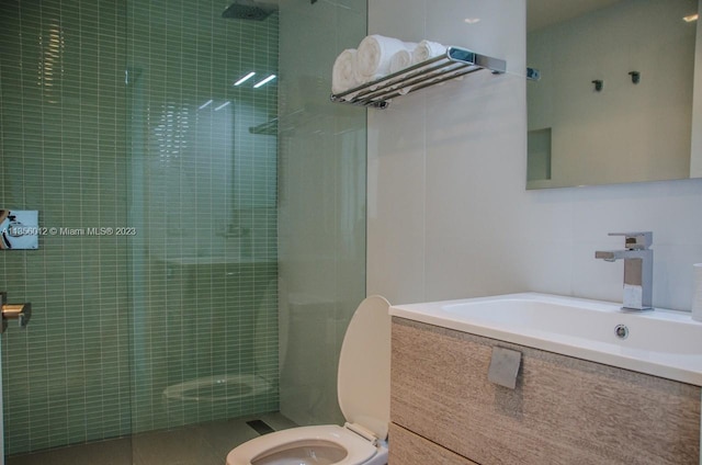 bathroom featuring toilet, an enclosed shower, and sink