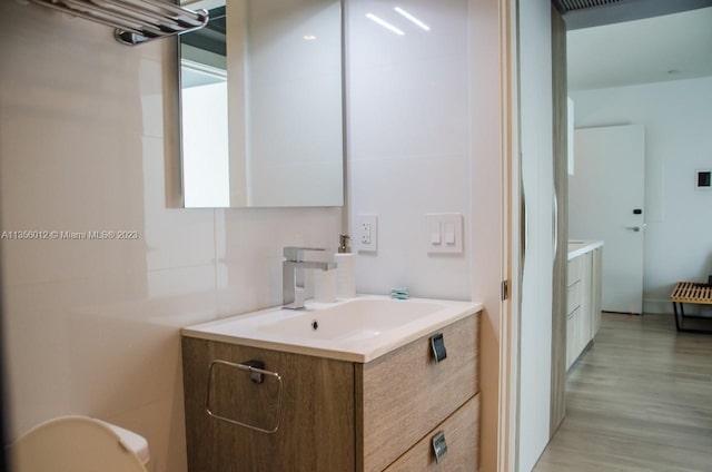 bathroom featuring hardwood / wood-style floors and vanity