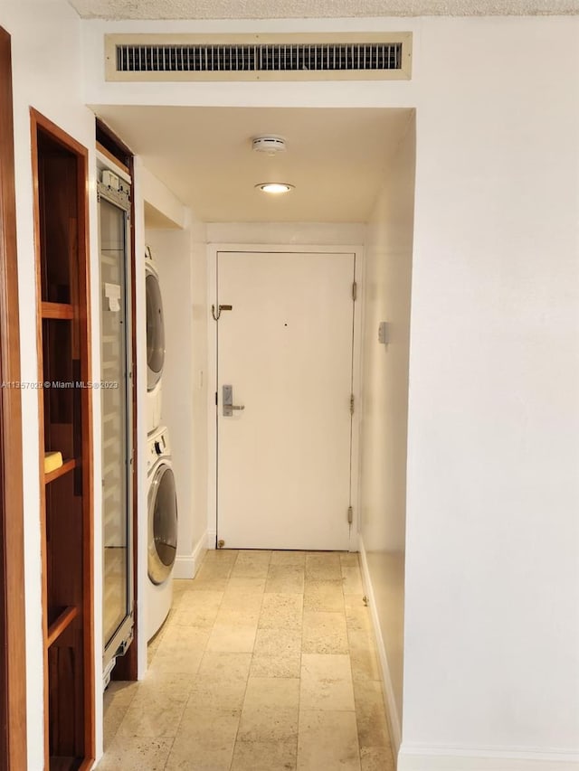 laundry area with stacked washer and clothes dryer