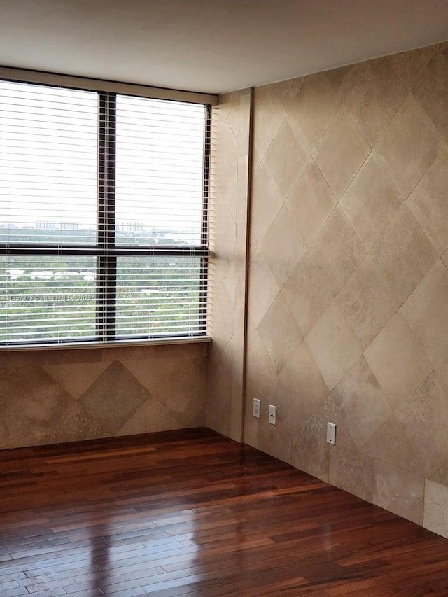 unfurnished room featuring hardwood / wood-style flooring