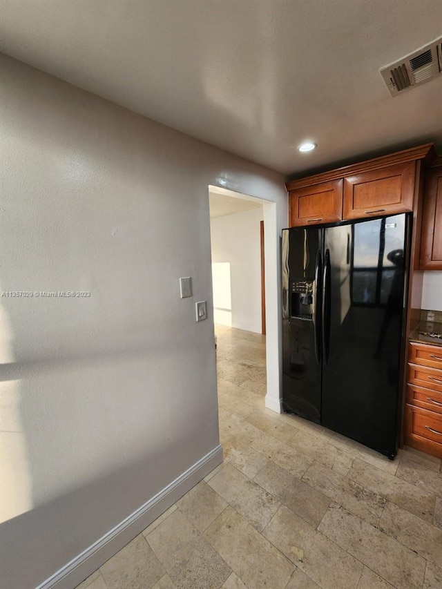 kitchen featuring black fridge with ice dispenser