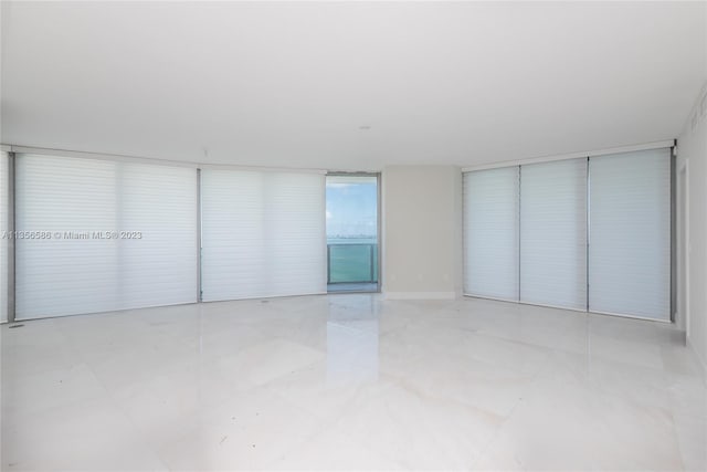 unfurnished room featuring light tile floors