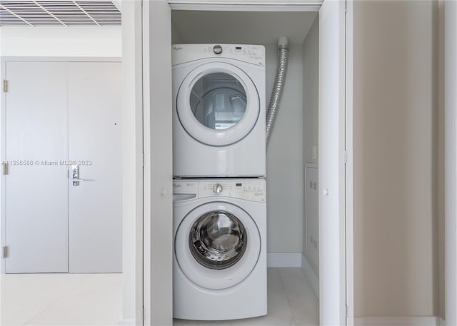 laundry area with stacked washing maching and dryer