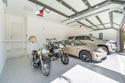 garage featuring a garage door opener and a carport