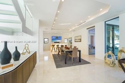 dining space with a raised ceiling