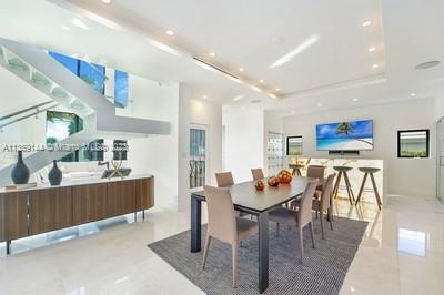 tiled dining room with a raised ceiling