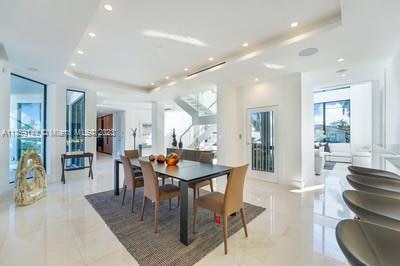 tiled dining room featuring a tray ceiling