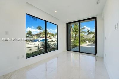 empty room featuring expansive windows and a wealth of natural light