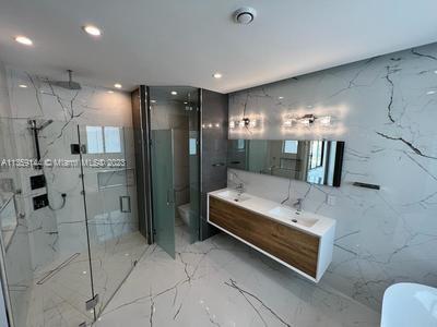 bathroom with vanity and an enclosed shower