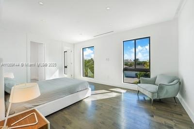 bedroom with dark hardwood / wood-style floors