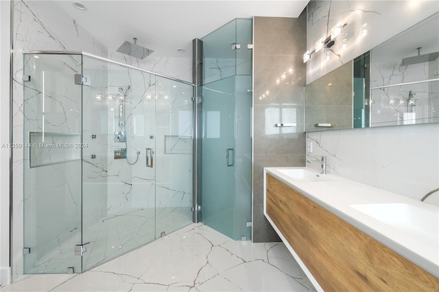 bathroom featuring vanity, an enclosed shower, and tile walls