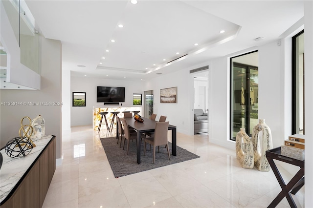 dining area featuring a raised ceiling