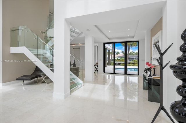 foyer with a tray ceiling