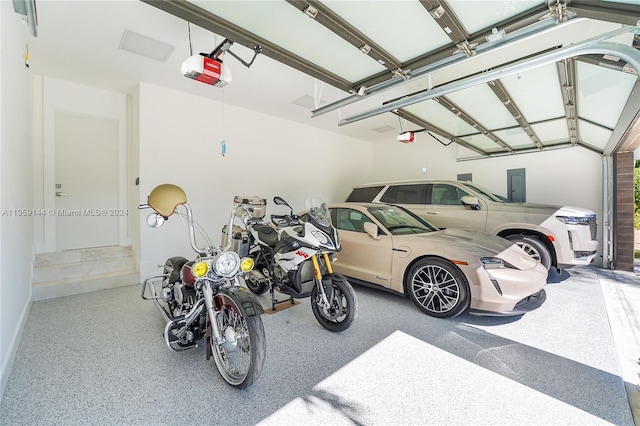 garage with electric panel and a garage door opener