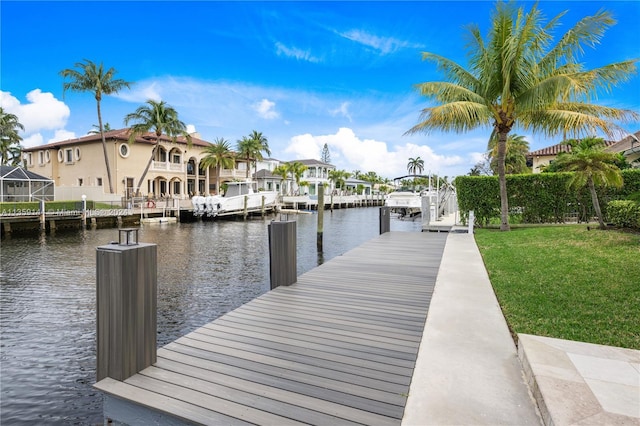 view of dock featuring a water view and a lawn