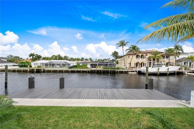 view of dock with a yard and a water view