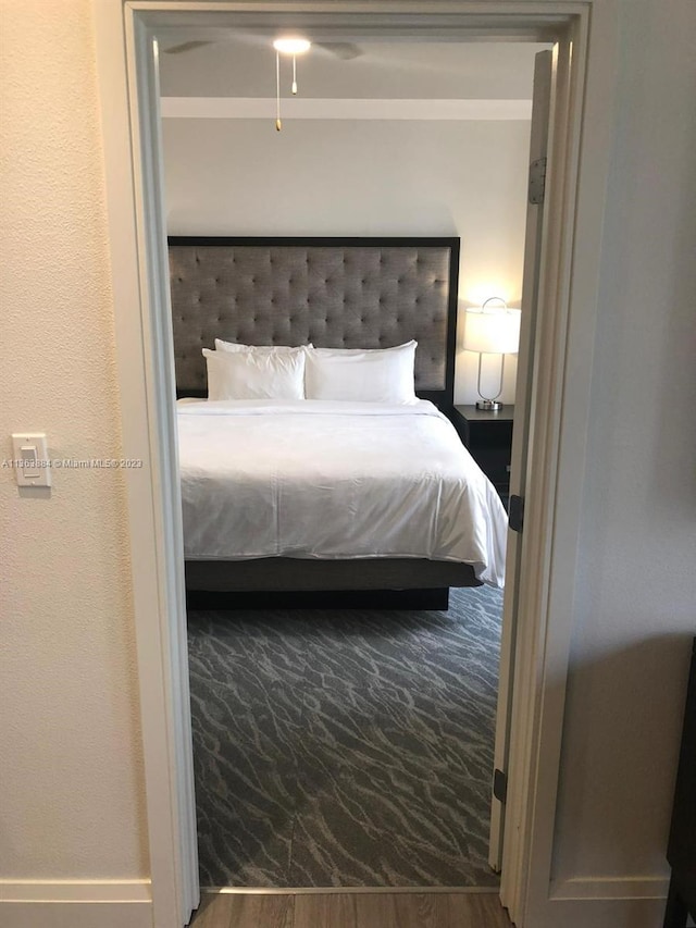 bedroom with dark hardwood / wood-style flooring and ceiling fan