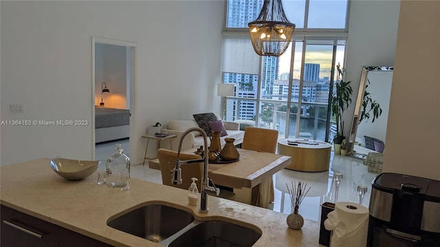 tiled dining space with sink and an inviting chandelier