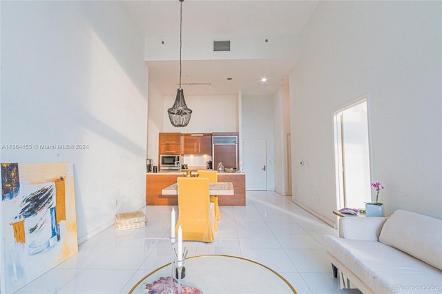 tiled dining area with a high ceiling