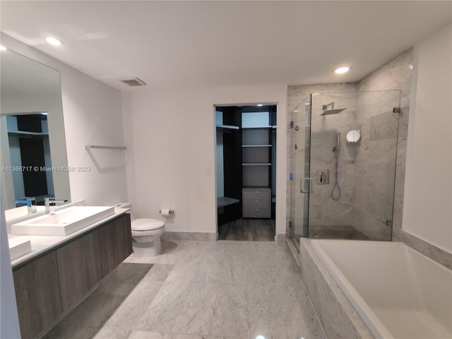 full bathroom featuring toilet, shower with separate bathtub, and vanity