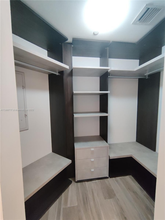 walk in closet featuring light hardwood / wood-style flooring